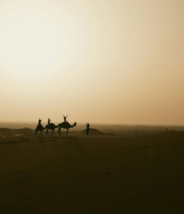 Traditional nomadic yurt standing in vast Kazakhstan steppe during golden sunset hour